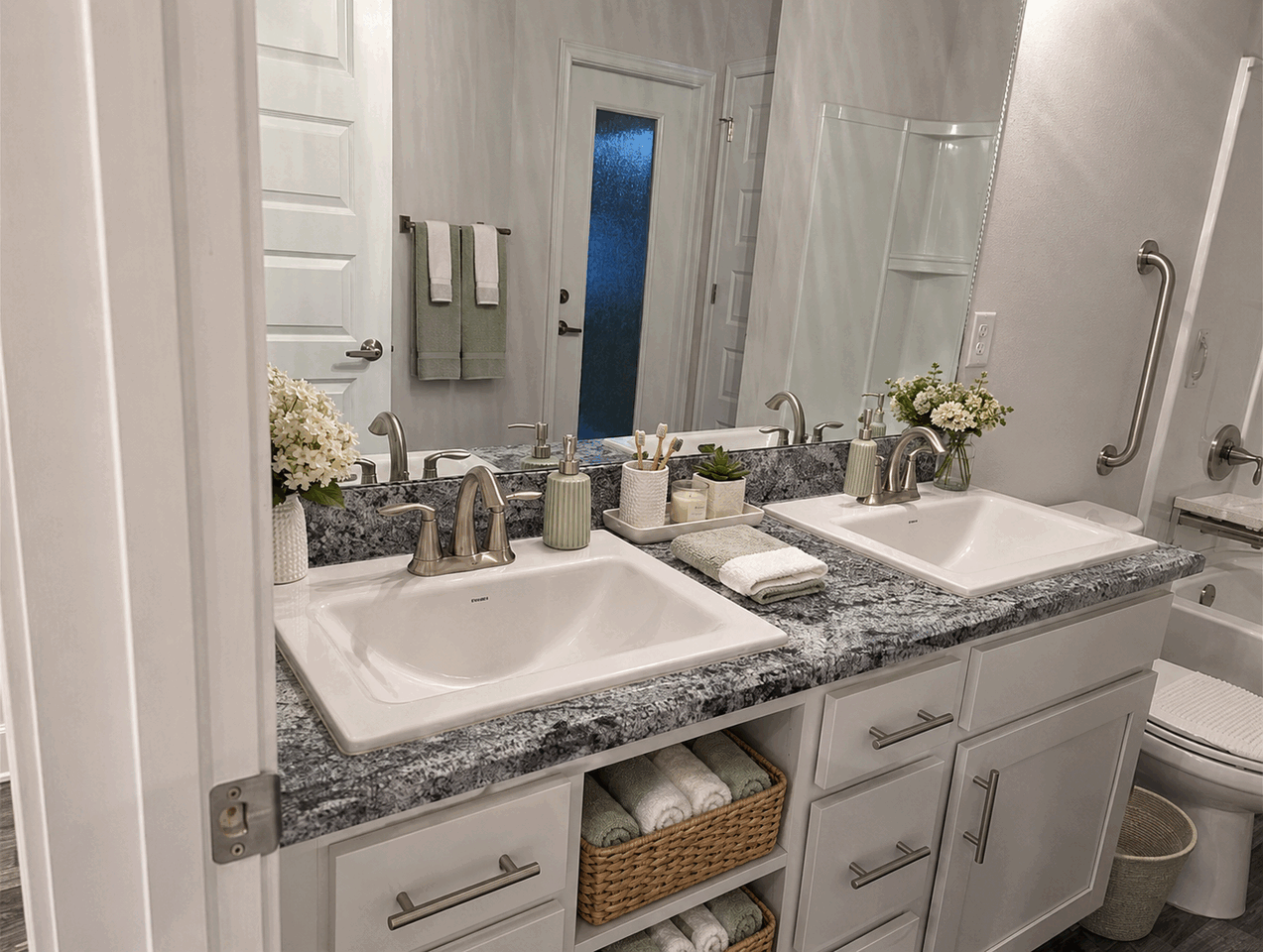 Organized double-vanity bathroom with bathing safety accessories